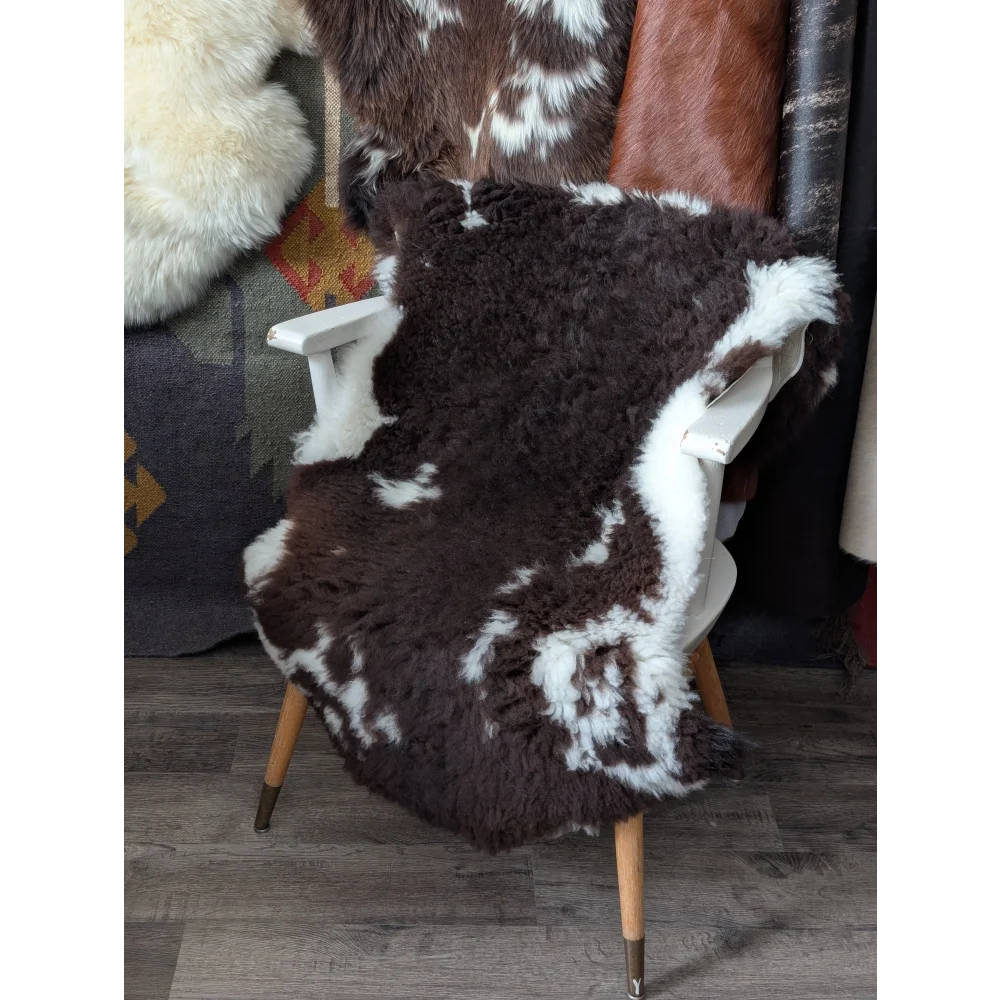 Fluffy cloud like oeko tex cowhide rug on white wooden chair