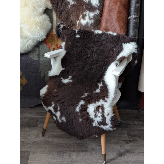 Fluffy cloud like oeko tex cowhide rug on white wooden chair
