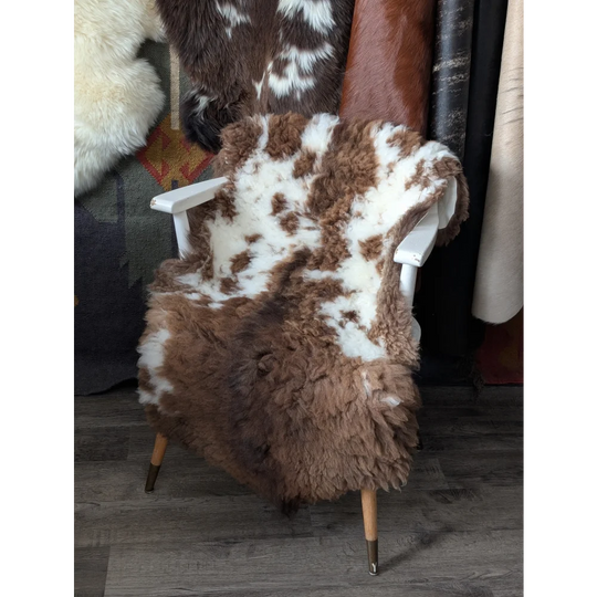 Cozy 42x26.5 fluffy cloud cowhide throw on white chair, oeko tex natural colours