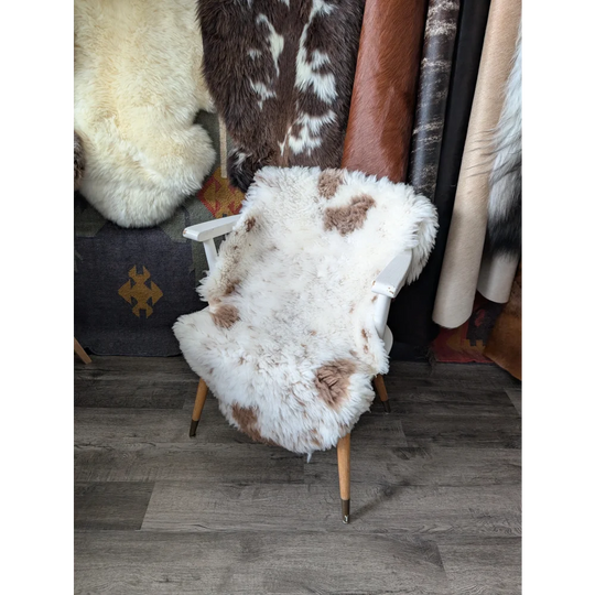 Fluffy cloud sheepskin rug CSA15 draped on white wooden chair