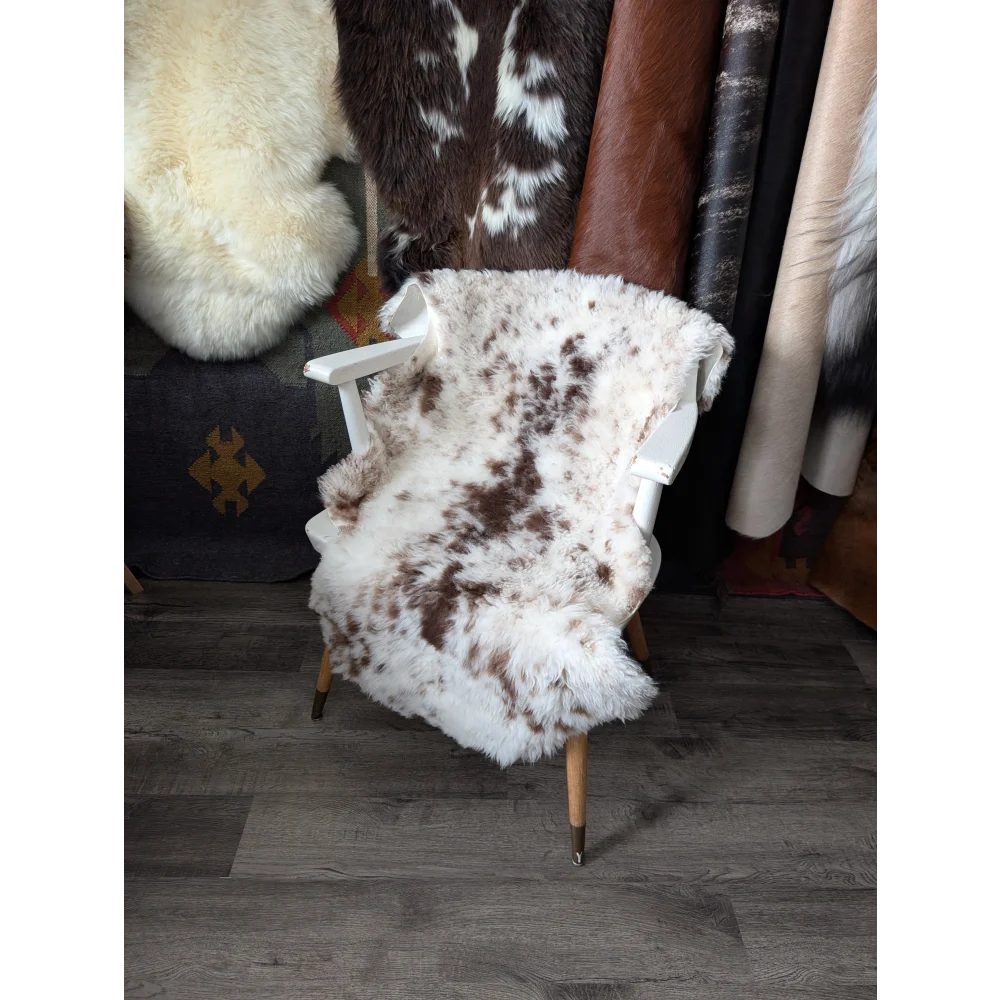 White armchair with fluffy cloud Oeko-Tex sheepskin rug