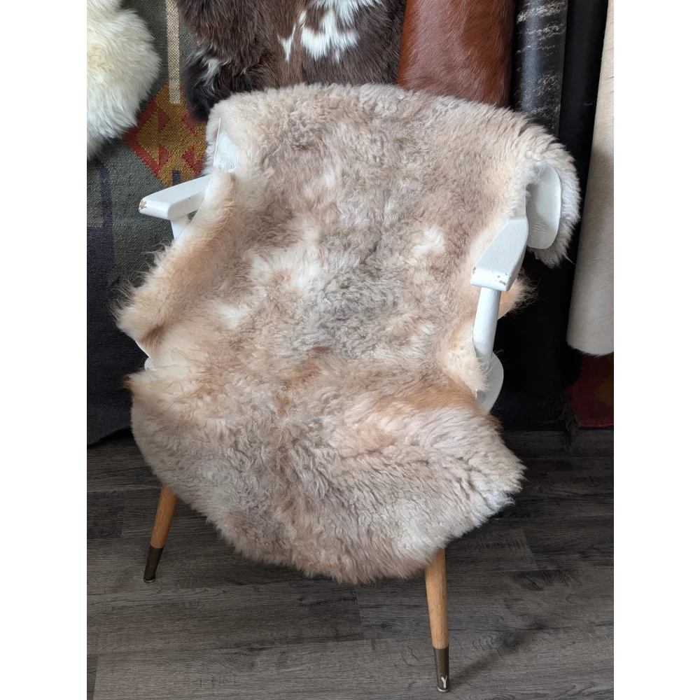 Fluffy cloud like oeko tex sheepskin rug on white wooden chair