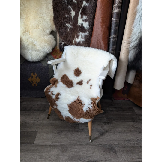 Fluffy cloud oeko tex sheepskin cowhide blanket on wooden chair
