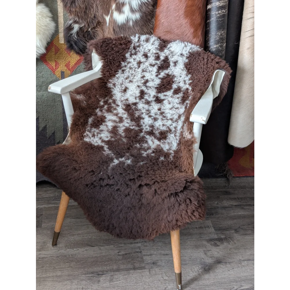 Fluffy cloud oeko tex sheepskin rug in natural colours on white chair