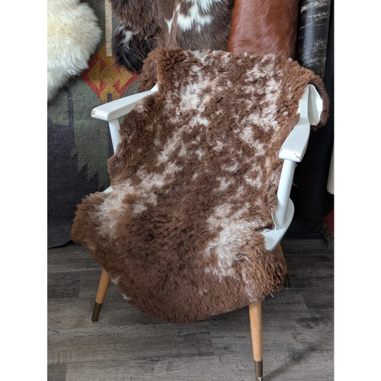 Fluffy cloud like 42.5x26 sheepskin rug on white chair