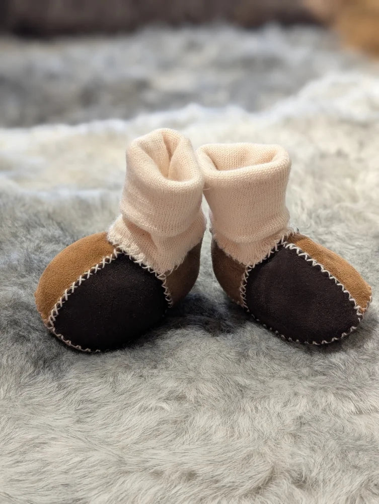 Fabulous sheepskin baby booties in brown and black with cream cuffs and white stitching