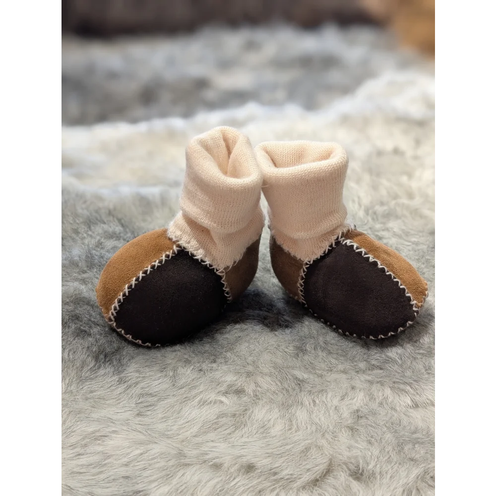 Fabulous sheepskin baby booties in brown and black with cream cuffs and white stitching