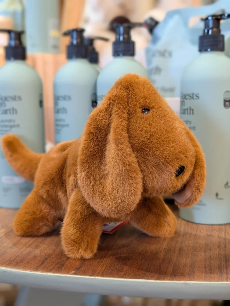 A plush tan dachshund toy with floppy ears and soft fuzzy texture perfect for cuddling or playing