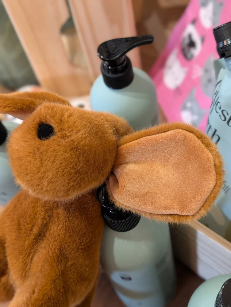 A plush tan dachshund toy with soft fur and suede textured inner ears perfect for cuddling