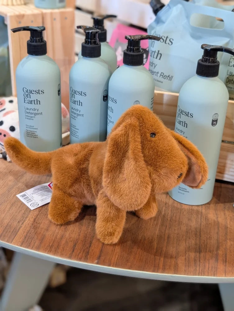 A plush tan dachshund toy with floppy ears and soft fuzzy texture perfect for cuddling and playtime