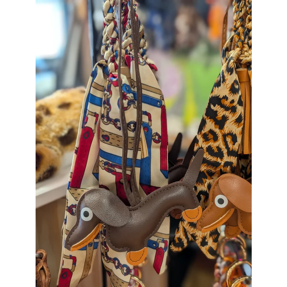 Dark brown dachshund bag charm by Angus Oliver with orange accents