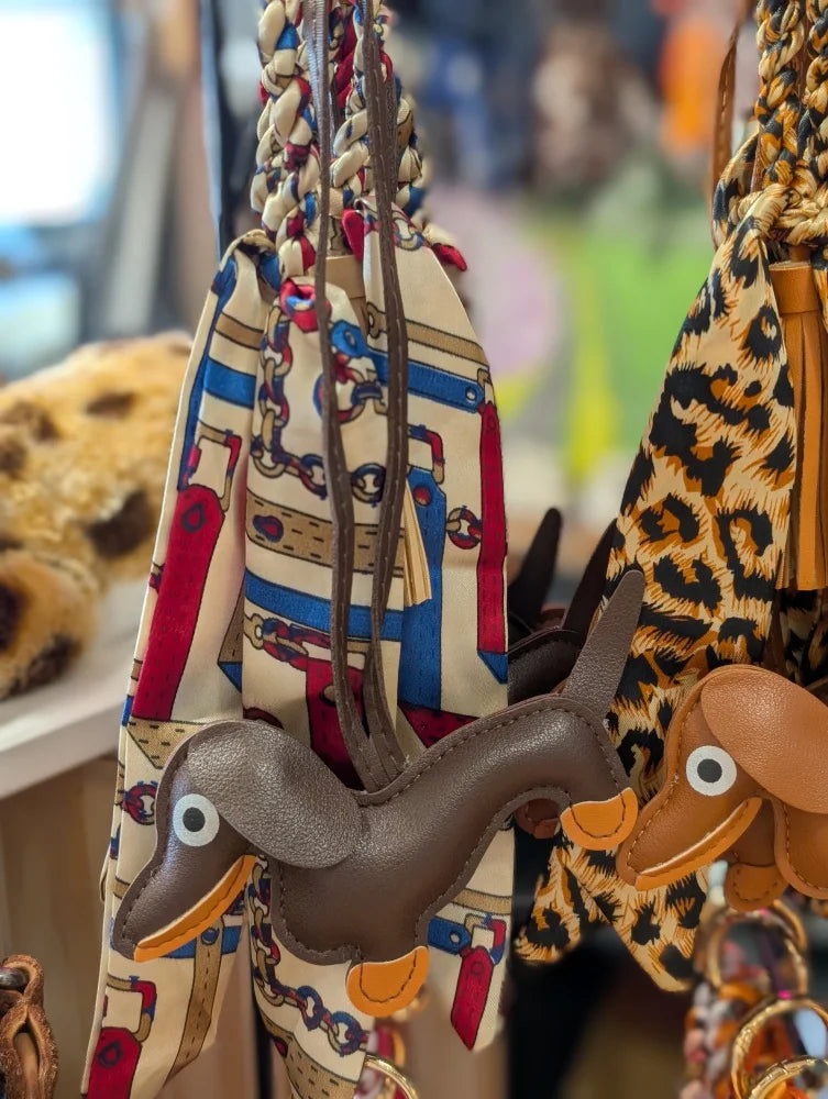 Dark brown dachshund bag charm by Angus Oliver with orange accents