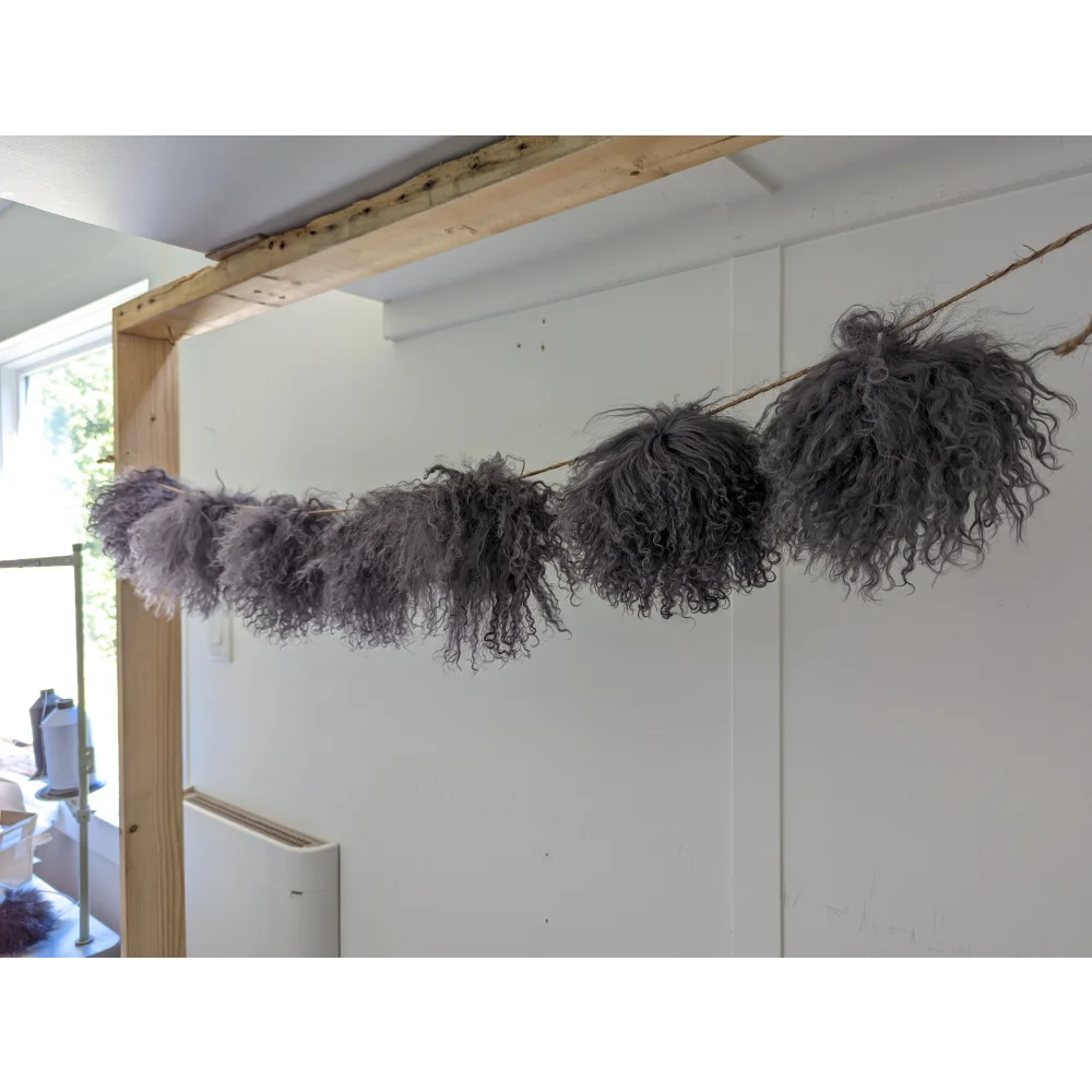 Dark grey sheepskin pom pom garland with fluffy gray accents
