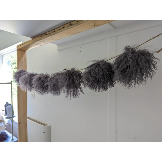 Dark grey sheepskin pom pom garland with fluffy gray accents