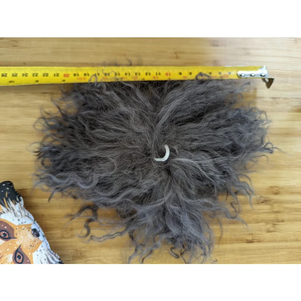 Dark grey sheepskin pom pom with grey curly hair extension and white band