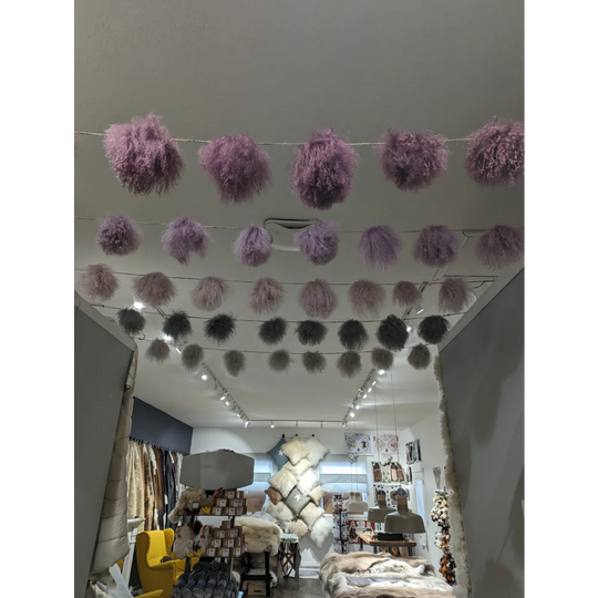 Dark grey sheepskin pom pom garland with lavender fur and silver accents