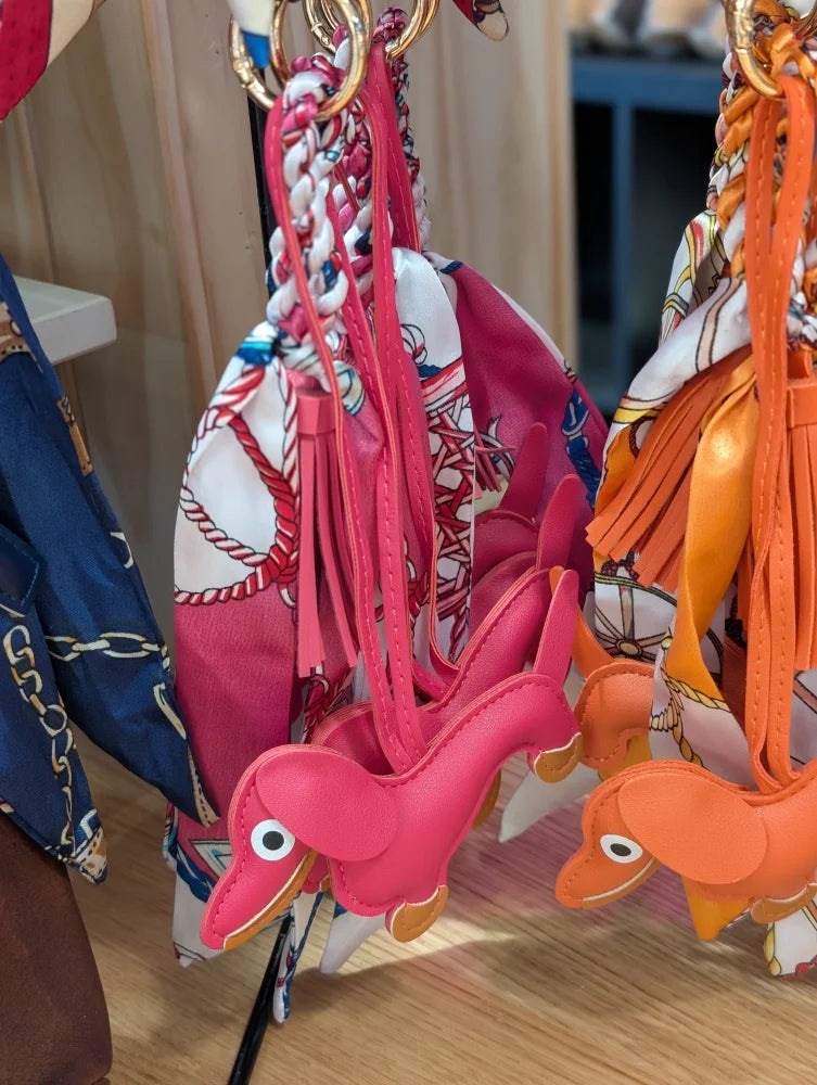 Dark pink dachshund bag charm with pink orange leather, embroidered eyes