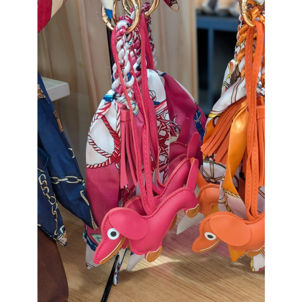 Dark pink dachshund bag charm with pink orange leather, embroidered eyes