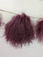 Dark pink curly synthetic hair extensions with sheepskin pom poms
