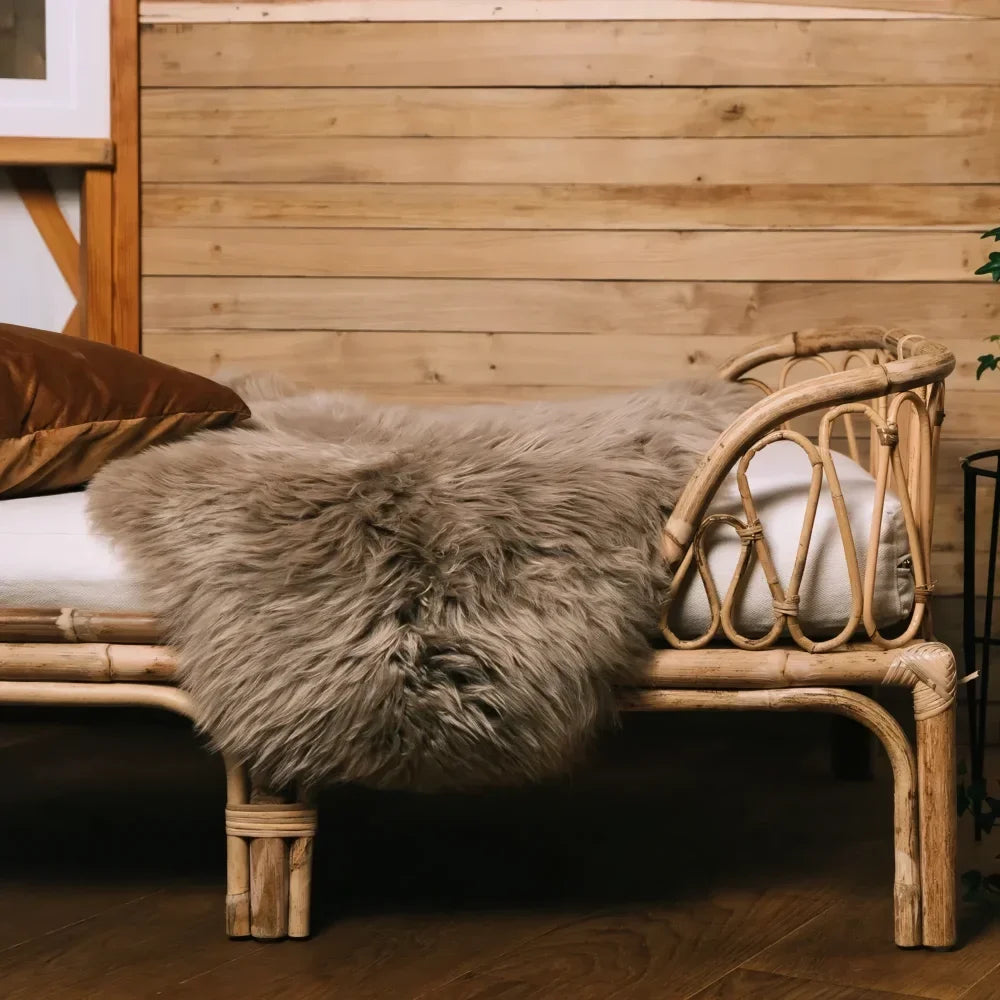 Rattan pet bed with plush gray dyed merino sheepskins blanket meeting strict european standards