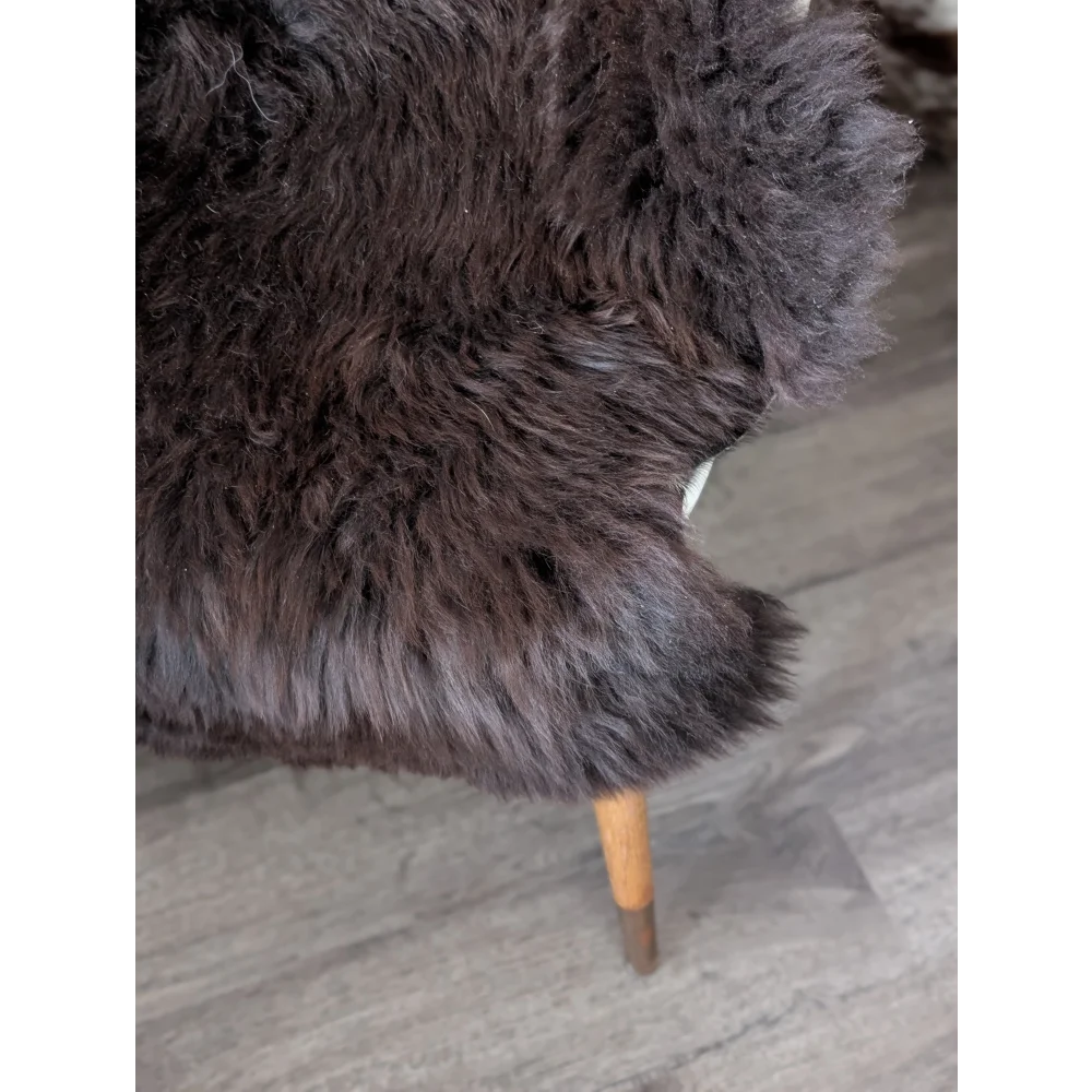 Dark brown fluffy British sheepskin chair with wooden legs, 44x31 inches