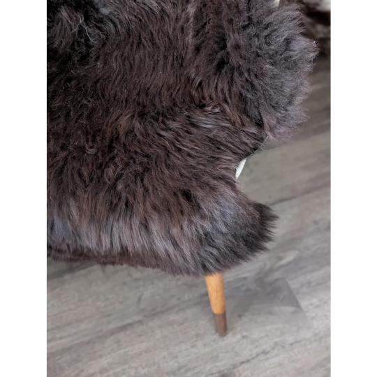 Dark brown fluffy British sheepskin chair with wooden legs, 44x31 inches