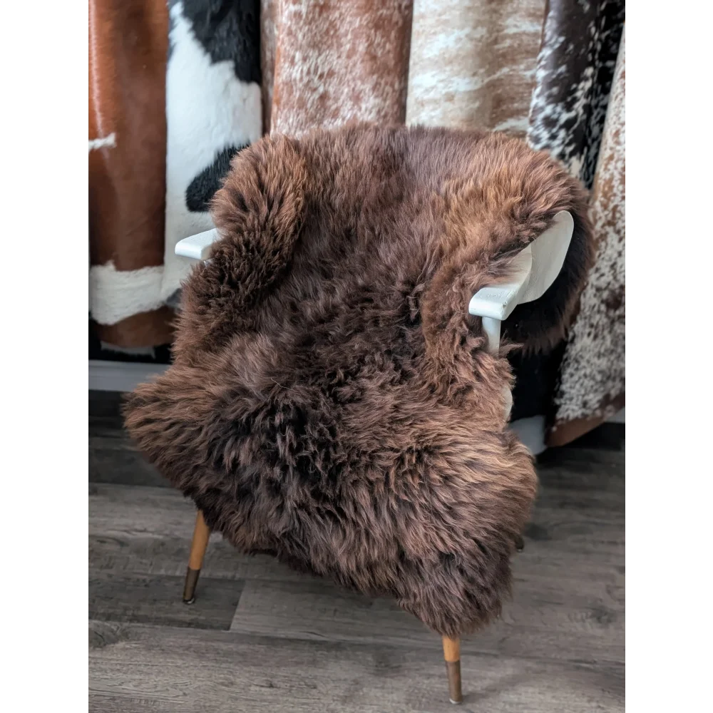 Gorgeous fluffy rare British sheepskin rug on white wooden chair