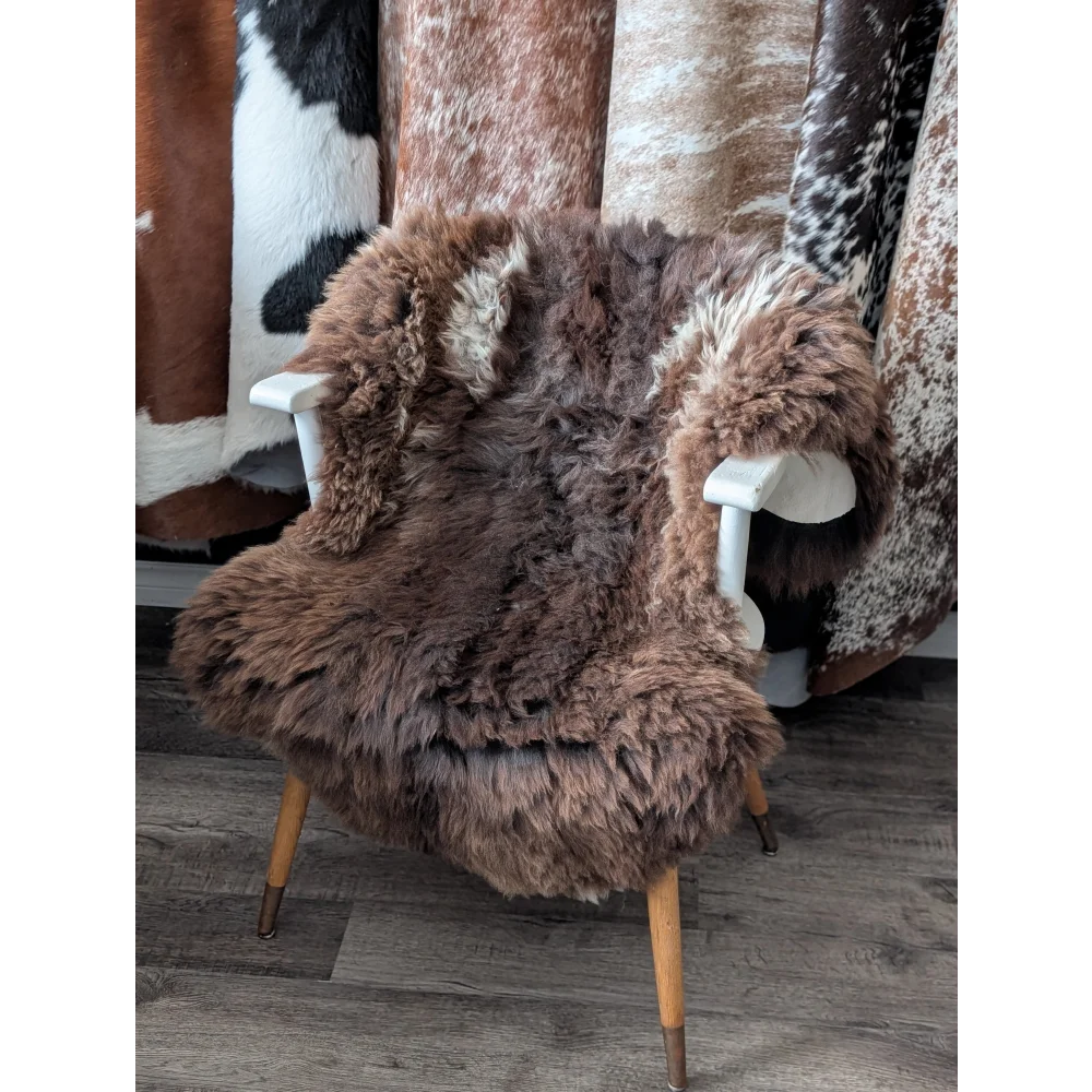 Gorgeous fluffy 47x33 British sheepskin rug on white armchair