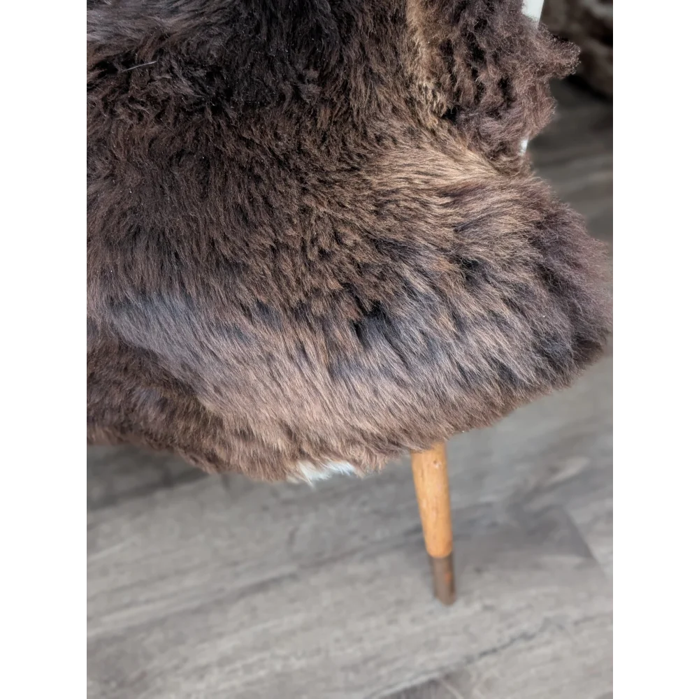 Gorgeous fluffy rare British sheepskin rug draped over wooden chair leg