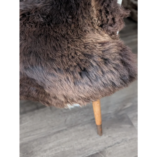 Gorgeous fluffy rare British sheepskin rug draped over wooden chair leg