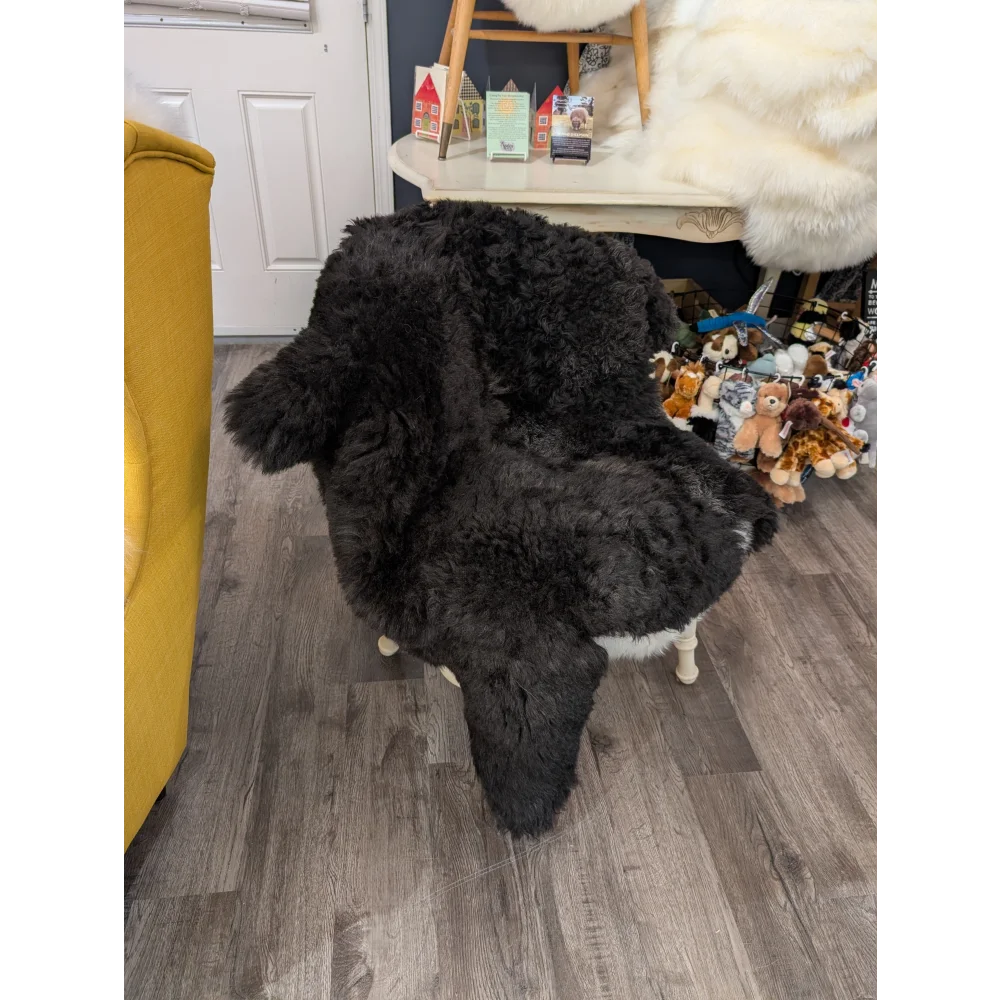 Black double icelandic sheepskin chair cover with long wool icelandic texture and white trim by angus oliver