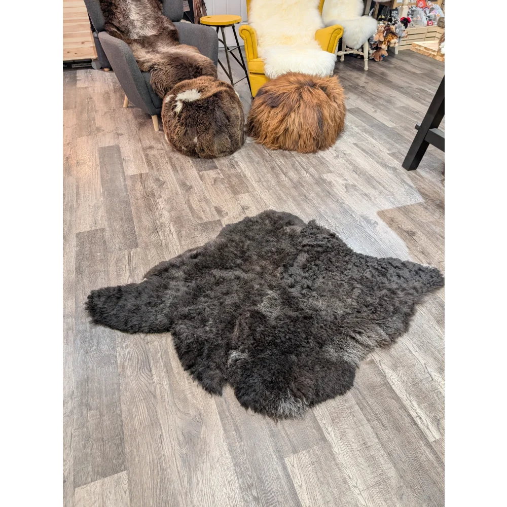 A plush dark gray double icelandic sheepskin rug with long wool texture by angus oliver measuring 46 x 38 inches