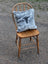 Gray and white speckled double sided cowhide cushion with black steer head silhouette from mini moo double collection