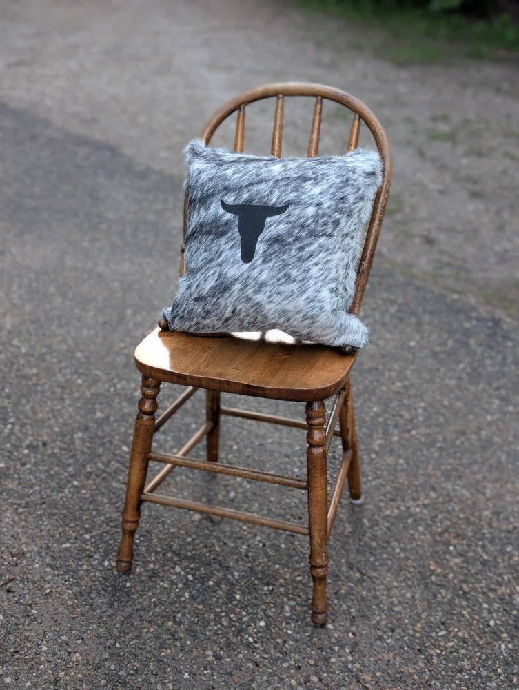 Gray and white speckled double sided cowhide cushion with black steer head design for mini moo double fans