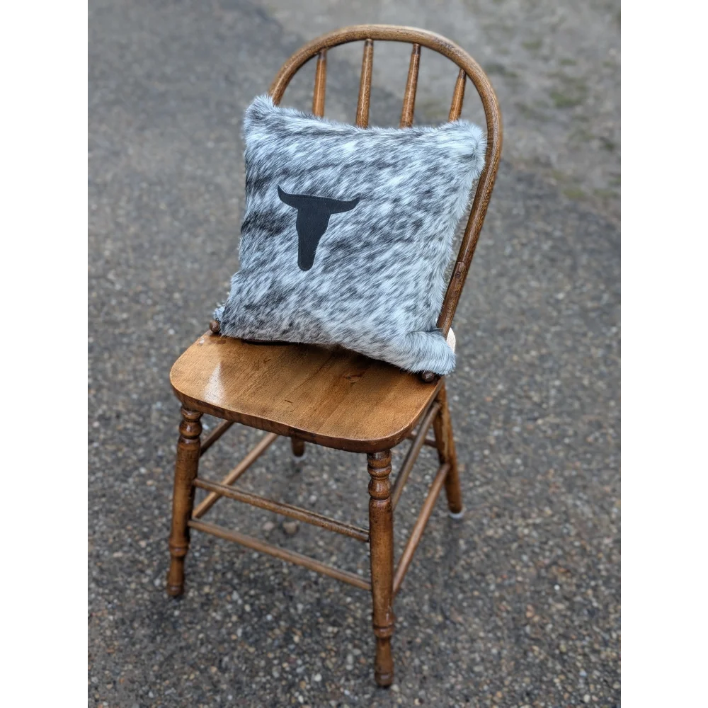 Gray and white speckled double sided cowhide cushion with black steer head silhouette from mini moo double collection