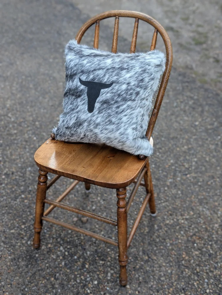 Gray and white speckled double sided cowhide cushion with black steer head silhouette from mini moo double collection