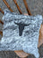 Gray and white speckled double sided cowhide cushion with black stitched bull head emblem from mini moo double