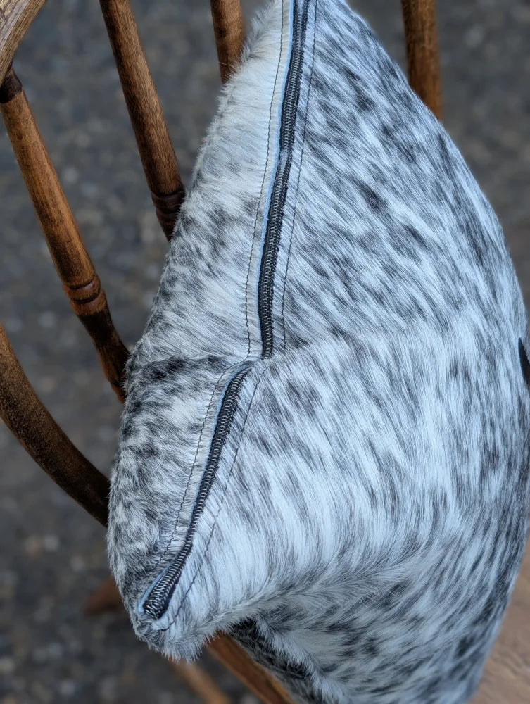 A soft gray and black double sided cowhide cushion with a visible zipper from mini moo double collection