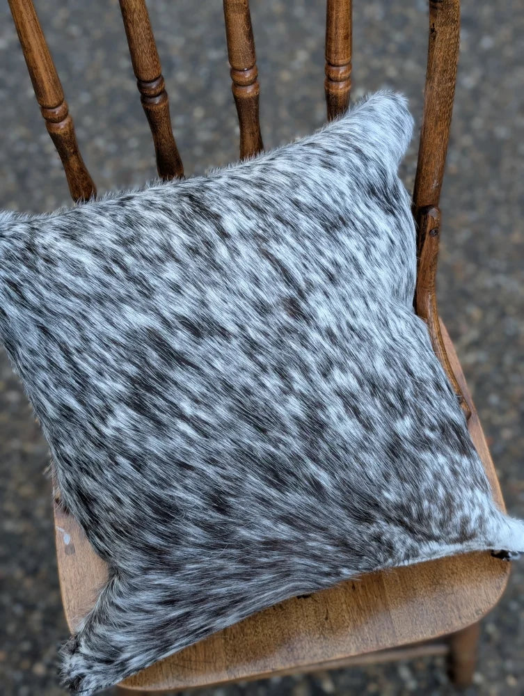 Gray and black speckled double sided cowhide cushion mini moo double with a soft textured surface