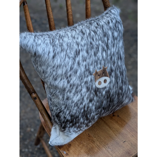 Gray and white speckled double sided cowhide cushion with wooden mini moo double cow face appliqué
