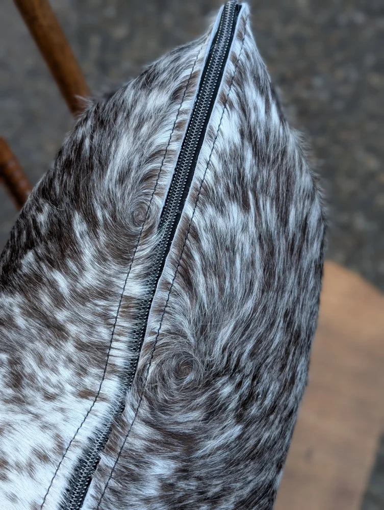 Gray and white spotted double sided cowhide cushion mini moo with a black zipper on the side