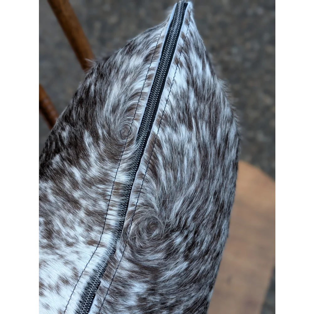 Gray and white spotted double sided cowhide cushion mini moo with a black zipper on the side