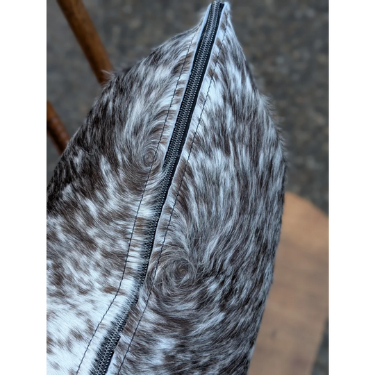 Gray and white spotted double sided cowhide cushion mini moo with a black zipper on the side