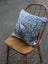 Gray and white speckled double sided cowhide cushion with a mini moo double brown pig face appliqué
