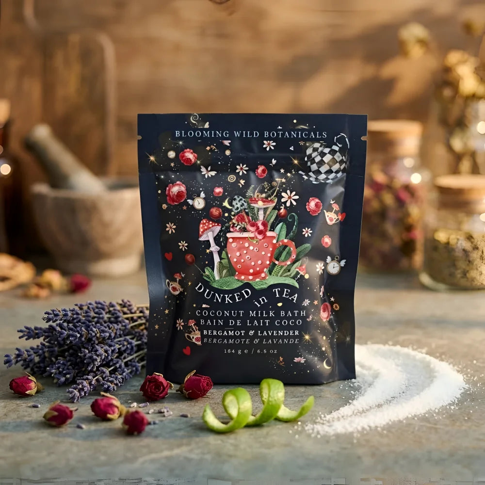 A dark blue pouch of angus oliver dunked in tea coconut milk bath salts from canada with a whimsical red teapot design