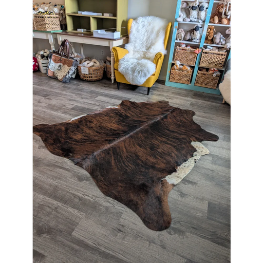 Large cowhide rug with brown and white natural irregular edges perfect for beautiful rugs decor
