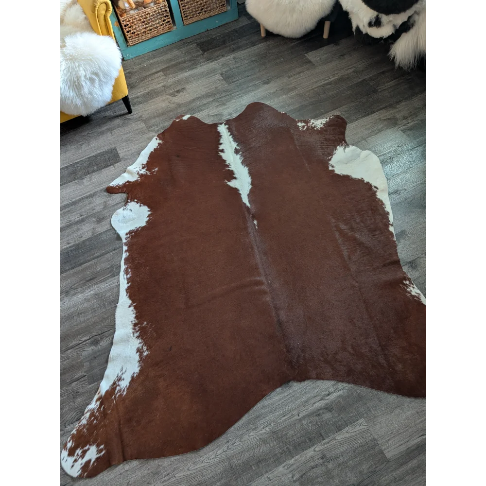 Large brown and white cowhide rug with natural fur texture perfect for adding style to beautiful rugs collections
