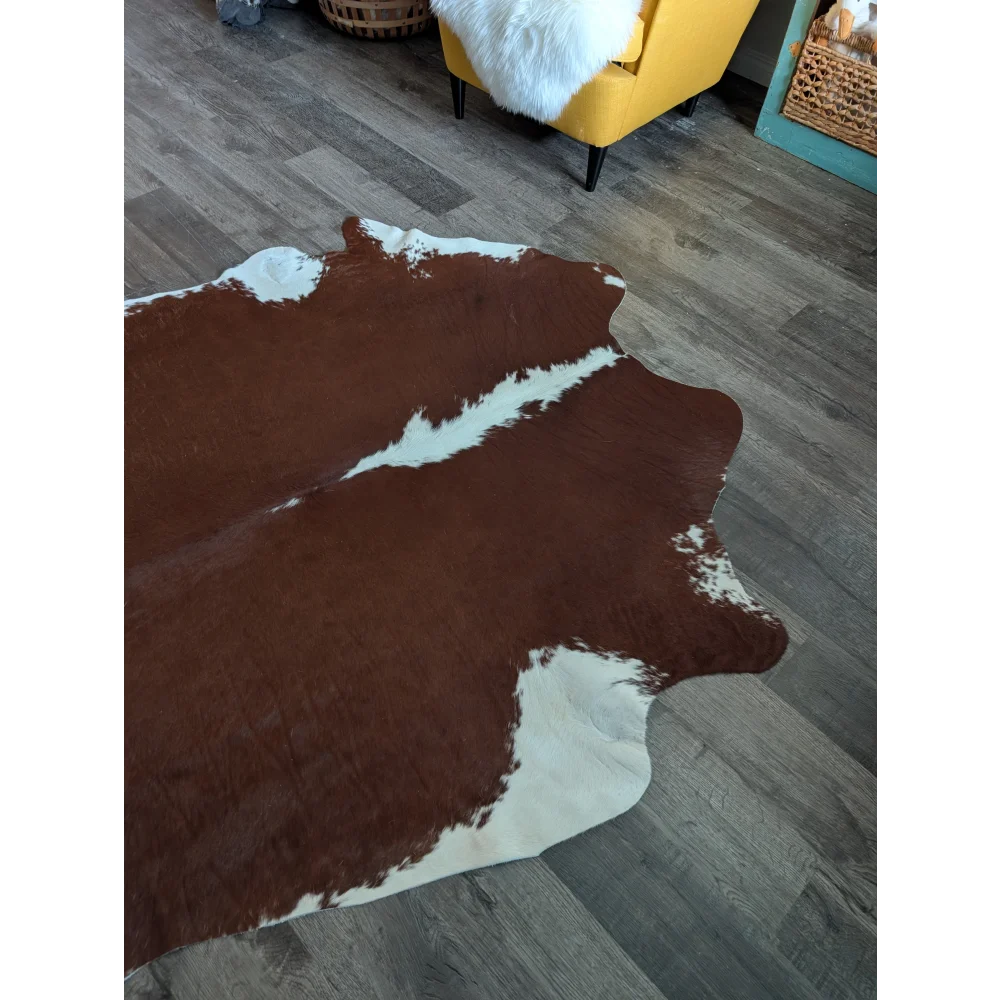 Large brown and white cowhide rug with natural irregular edges perfect for beautiful rugs and home decor