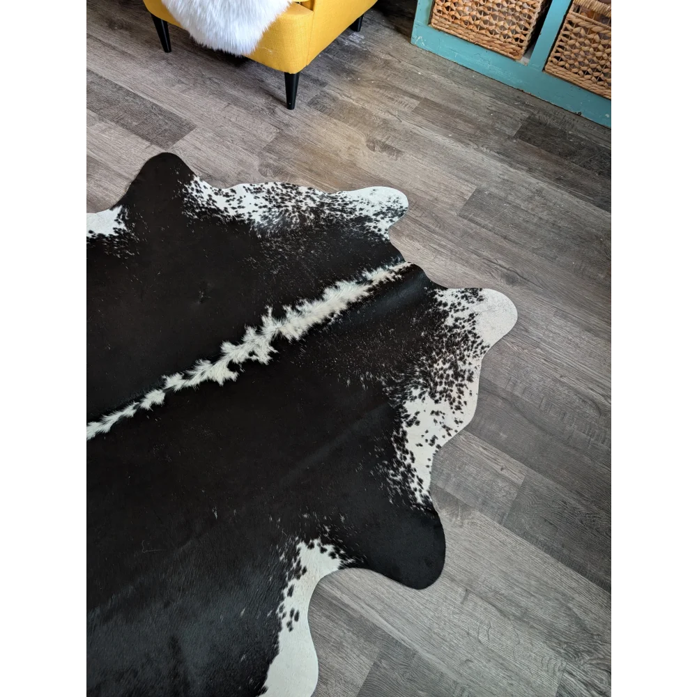 Large black and white cowhide rug with natural irregular edges perfect for beautiful rugs and decor
