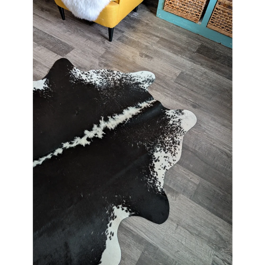 Large black and white cowhide rug with natural irregular edges perfect for beautiful rugs and decor